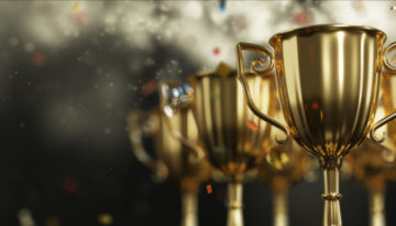 Golden trophy cup on dark background. copy space for text. 3d rendering.