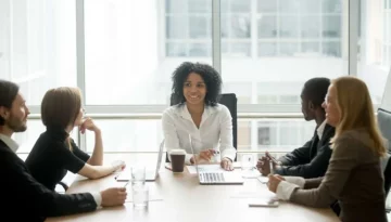 Smiling friendly african female boss leading corporate diverse team