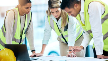 Architect, team and meeting in blueprint planning for construction, architecture or project collaboration. Group of contractors discussing floor plan or teamwork strategy for industrial architecture