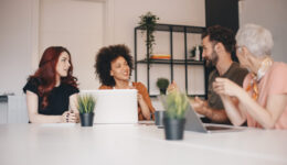 Small group of happy business colleagues talking on a meeting