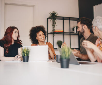 Small group of happy business colleagues talking on a meeting